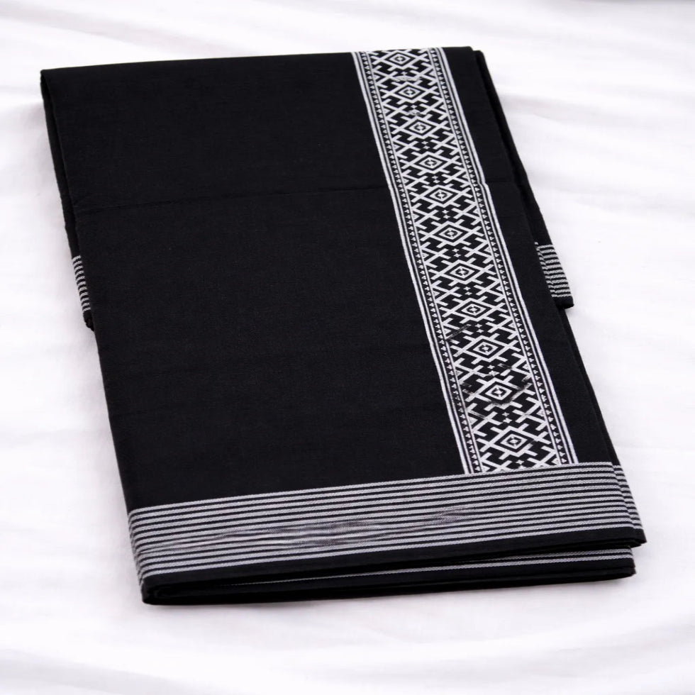 Black printed dhoti with traditional design, handwoven by Ramachandra Kuthampully Handlooms.