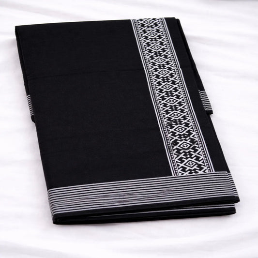 Black printed dhoti with traditional design, handwoven by Ramachandra Kuthampully Handlooms.