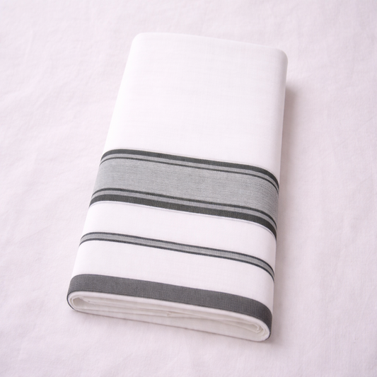 White double mundu with elegant classic kara, traditional Kerala handloom by Ramachandra Kuthampully Handlooms.